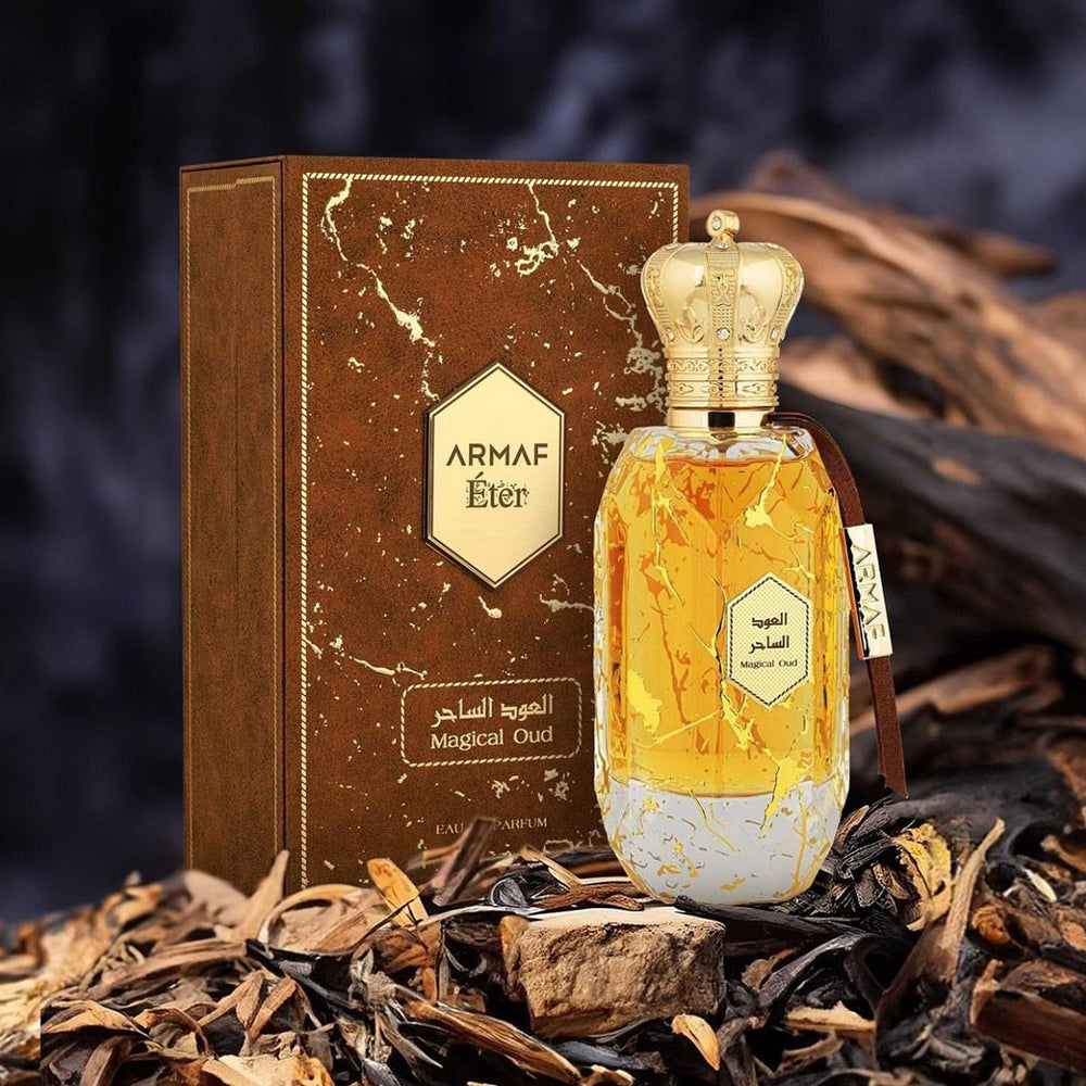 Armaf Magical Oud perfume from the Éter Collection with box and bottle on oud wood background.