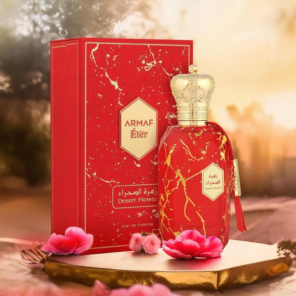 Armaf Desert Flower perfume from the Éter Collection displayed with matching red box and golden crown cap.