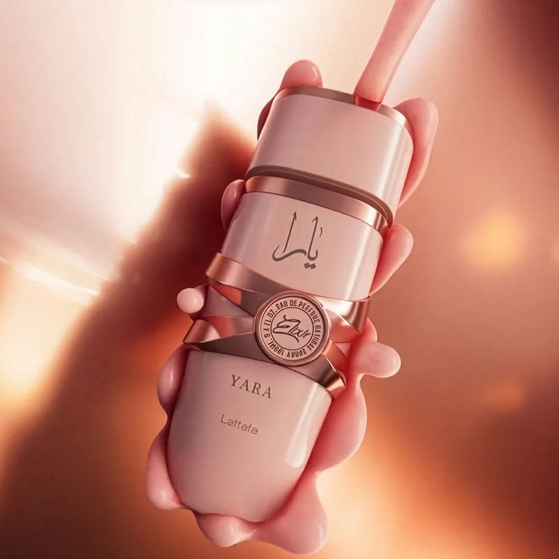 Lattafa Yara Elixir Eau de Parfum 100ml bottle in elegant pink and rose gold design, luxury feminine fragrance.