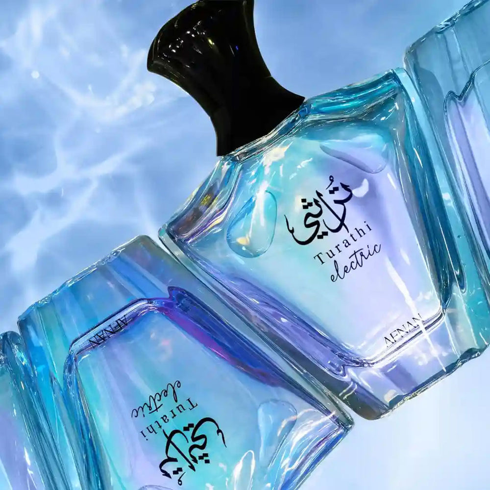 Turathi Electric perfume bottles by Afnan with blue water reflection