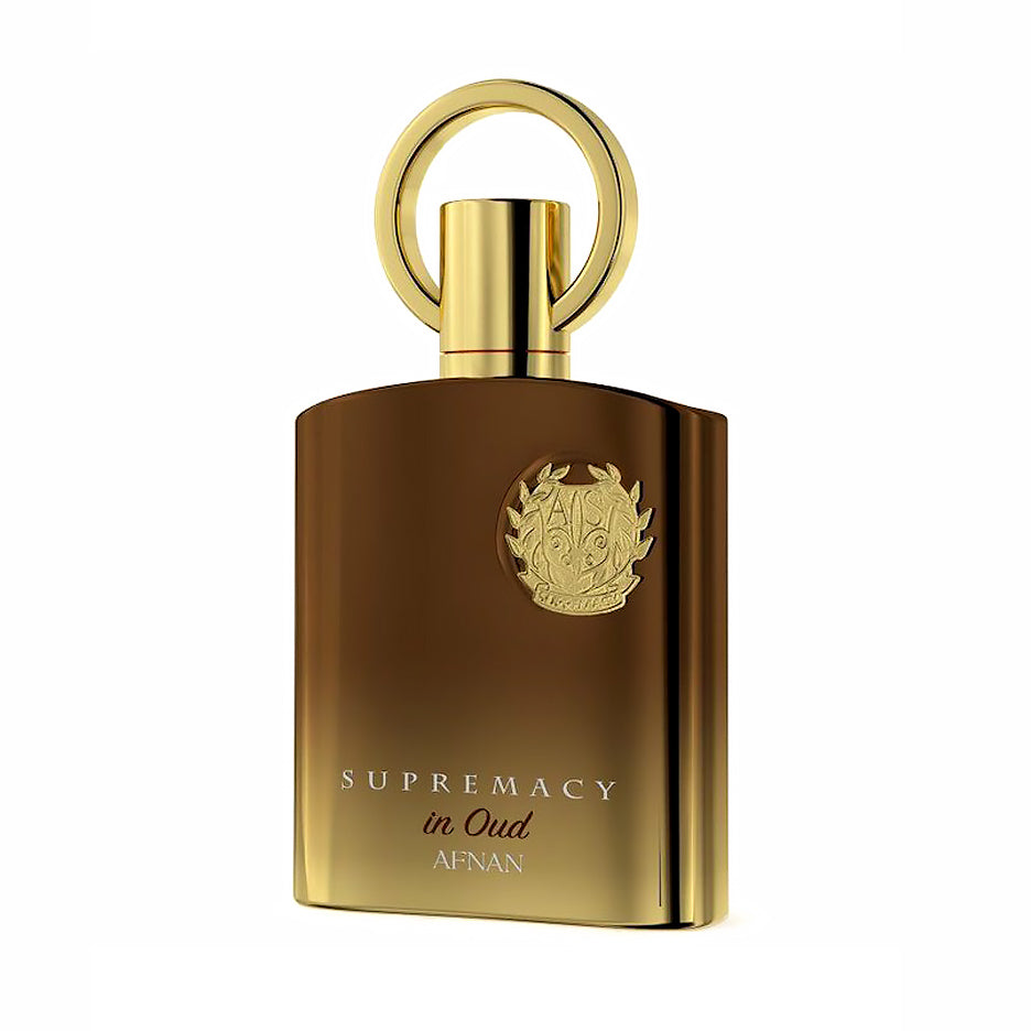 Afnan Supremacy in Oud bronze and gold perfume bottle with a ring-shaped cap on a white background.